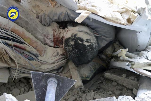 A body under the ruble of a destroyed building following an airstrike, at Bustan al-Basha neighbourhood in Aleppo, Syria. (Syrian Civil Defense White Helmets via AP) A body under the ruble of a destroyed building following an airstrike, at Bustan al-Basha neighbourhood in Aleppo, Syria. (Syrian Civil Defense White Helmets via AP)