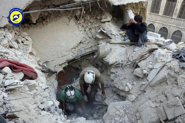 Civil Defense workers from the White Helmets digging in the rubles to remove bodies and look for survivors, after airstrikes hit the Bustan al-Basha neighbourhood in Aleppo, Syria. (Syrian Civil Defense White Helmets via AP) Civil Defense workers from the White Helmets digging in the rubles to remove bodies and look for survivors, after airstrikes hit the Bustan al-Basha neighbourhood in Aleppo, Syria. (Syrian Civil Defense White Helmets via AP)