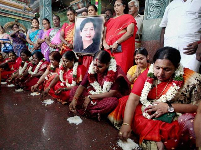 AIADMK members eat food from the floor as a prayer for a speedy recovery of party supremo and chief minister J Jayalalithaa, at a temple in Chennai. (PTI Photo)