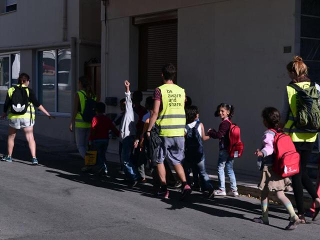 Refugee children are escorted by volunteers for their class at the Refugee Education Chios centre on the Greek island of Chios. (AFP File Photo) Refugee children are escorted by volunteers for their class at the Refugee Education Chios centre on the Greek island of Chios. (AFP File Photo)