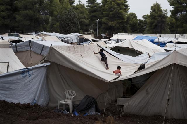 Syrian children play on the top of a tent at the Ritsona camp for refugees and other migrants north of Athens. (AP Photo) Syrian children play on the top of a tent at the Ritsona camp for refugees and other migrants north of Athens. (AP Photo)