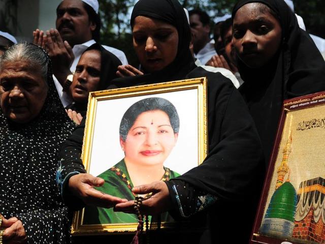 People hold a portrait of Tamil Nadu chief minister J Jayalalitha as they pray for her wellbeing front of a hospital where she is being treated in Chennai. (AFP Photo) People hold a portrait of Tamil Nadu chief minister J Jayalalitha as they pray for her wellbeing front of a hospital where she is being treated in Chennai. (AFP Photo)