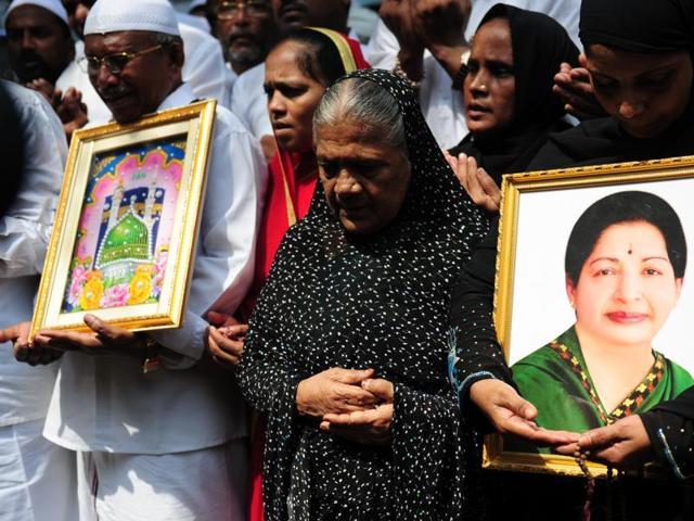 People hold a portrait of Tamil Nadu Chief Minister Jayalalitha as they pray for her wellbeing in front of a hospital where she was being treated in Chennai on October 5, 2016.(AFP)