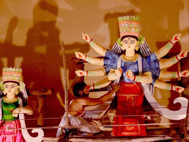 An artist makes an idol of Goddess Durga for a pandal at Vashi, Navi Mumbai on Thursday. (PTI) An artist makes an idol of Goddess Durga for a pandal at Vashi, Navi Mumbai on Thursday. (PTI)