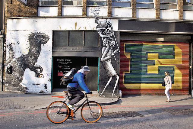 Belgian street artist ROA’s Weasel on Great Eastern Street. Standing next to works by Ben Eine (coloured letterform ‘E’ at present swallowed by a sea of tags) and Phlegm’s bizarre character (Corbis via Getty Images) Belgian street artist ROA’s Weasel on Great Eastern Street. Standing next to works by Ben Eine (coloured letterform ‘E’ at present swallowed by a sea of tags) and Phlegm’s bizarre character (Corbis via Getty Images)