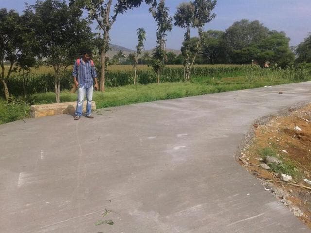 Professor Nemkumar Banthia (centre) in Thondebavi village in Karnataka where the new self-repairing road, based on advanced technology, was built recently.(Courtesy UBC)