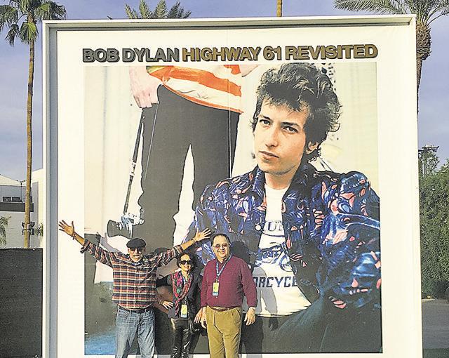 Krishna Dhawan (R) who travelled to California for the Desert Trip Festival poses with friends in front of a Bob Dylan poster at the festival. (Krishna Dhawan)