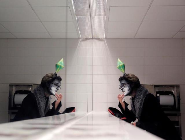 Brent Schlosshauer applies make-up to his Simms Pet costume in the bathroom at New York Comic Con in Manhattan, New York, US. (REUTERS) Brent Schlosshauer applies make-up to his Simms Pet costume in the bathroom at New York Comic Con in Manhattan, New York, US. (REUTERS)
