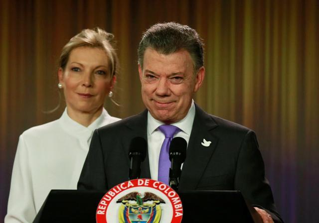 Santos smiles as he addresses the media next to his wife and first lady Maria Clemencia de Santos at Narino Palace in Bogota, Colombia (Reuters) Santos smiles as he addresses the media next to his wife and first lady Maria Clemencia de Santos at Narino Palace in Bogota, Colombia (Reuters)