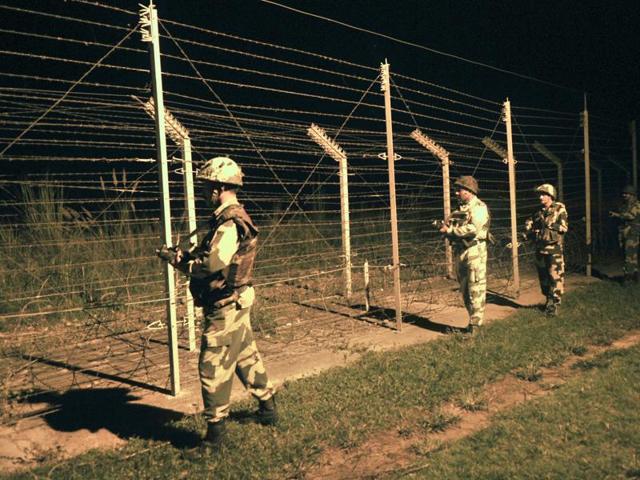 Border Security Force soldiers stand guard during a night patrol near a fence at the India-Pakistan International Border. (Nitin Kanotra/HT Photo) Border Security Force soldiers stand guard during a night patrol near a fence at the India-Pakistan International Border. (Nitin Kanotra/HT Photo)