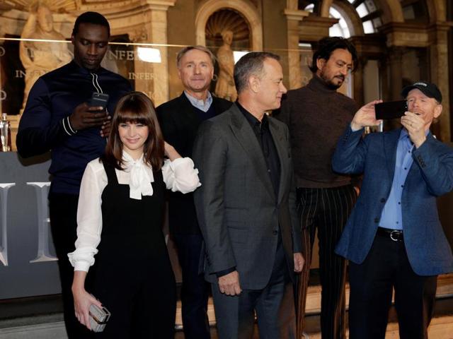 Director Ron Howard (R) takes a picture as he poses with the actors Tom Hanks (3rd R), Felicity Jones (2nd to L), Omar Sy (L), Irrfan Khan (2nd R) and writer Dan Brown at a screening of the film Inferno in Florence, Italy. (REUTERS) Director Ron Howard (R) takes a picture as he poses with the actors Tom Hanks (3rd R), Felicity Jones (2nd to L), Omar Sy (L), Irrfan Khan (2nd R) and writer Dan Brown at a screening of the film Inferno in Florence, Italy. (REUTERS)