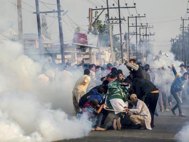 Family and friends huddle around the body of Junaid Ahmed, a 13-year-old boy who died of pellet injuries during a protest, while taking out his funeral procession on October 8, 2016. Police fired tear gas to dispel the growing crowds as Ahmed’s death breathed new life into the ‘azaadi’ (pro-independence) protests that entered its fourth month in the Valley. (AP) Family and friends huddle around the body of Junaid Ahmed, a 13-year-old boy who died of pellet injuries during a protest, while taking out his funeral procession on October 8, 2016. Police fired tear gas to dispel the growing crowds as Ahmed’s death breathed new life into the ‘azaadi’ (pro-independence) protests that entered its fourth month in the Valley. (AP)