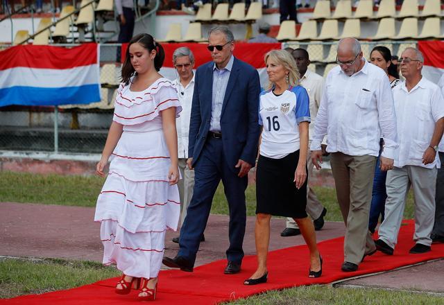 Dr. Jill Biden, wife of US Vice President Joe Biden, is escorted to the pitch prior to the match. (AFP)