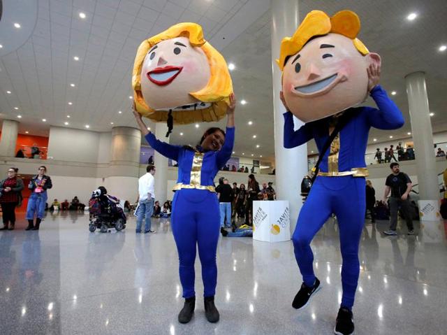 Participants Vanessa Pham and Adrian Chan remove their costumes of Vault Boy and Vault Girl at the event. (REUTERS) Participants Vanessa Pham and Adrian Chan remove their costumes of Vault Boy and Vault Girl at the event. (REUTERS)