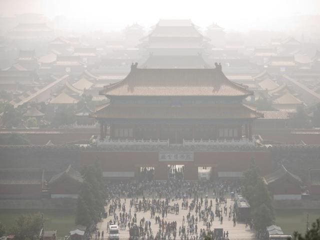 Tourists exit the Forbidden City on a day with high levels of air pollution in Beijing, Monday, Oct. 3, 2016.(AP Photo)