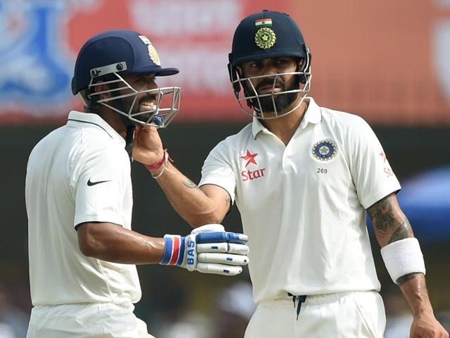 Kohli (R) fixes Rahane's helmet during a break. (AFP) 