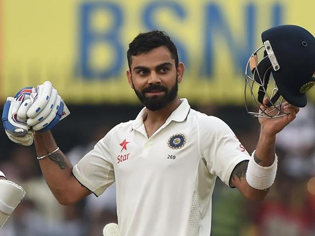 Kohli takes off his helmet and gloves and acknowledges the crowd on completing his 13th Test century. (AFP) 