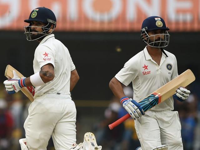 Rahane, left, and Kohli run between the wickets. (AFP) 