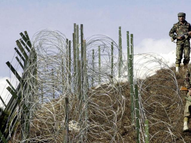 Indian soldiers patrol along a barbed-wire fence near Baras Post on the Line of Control (LoC) between Pakistan and India some 174 kms north west of Srinagar.(AFP File Photo)