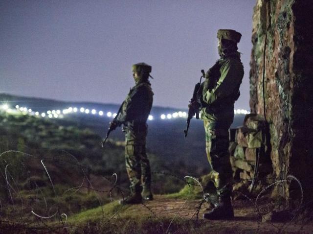 Soldiers stand guard at a forward post near the illuminated fence in Hamirpur area, about 180 km north west of Jammu. (HT File Photo) Soldiers stand guard at a forward post near the illuminated fence in Hamirpur area, about 180 km north west of Jammu. (HT File Photo)