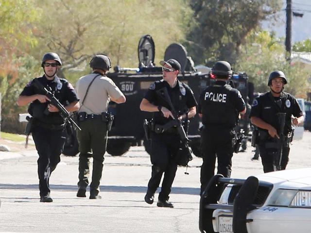Riverside Country Sheriffs Deputies walk along a street in Palm Springs, California, on October 8, 2016. Three officers were shot by a suspect while trying to settle a domestic dispute. (AP)