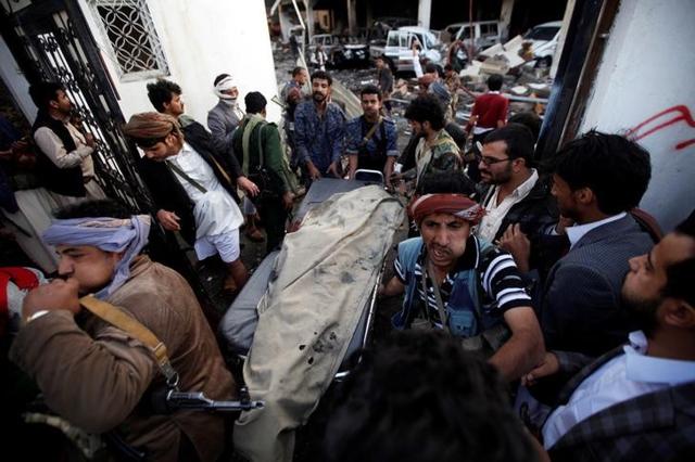 People carry the body of man killed in what witnesses said was an airstrike by Saudi-led coalition aircraft on mourners at a hall in Sanaa. (Reuters) People carry the body of man killed in what witnesses said was an airstrike by Saudi-led coalition aircraft on mourners at a hall in Sanaa. (Reuters)