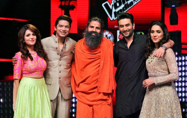 Swami Ramdev with Sugandha Mishra, Shaan, Shekhar Ravjiani and Neeti Mohan on the sets of a TV show in Mumbai on Monday. (PTI)