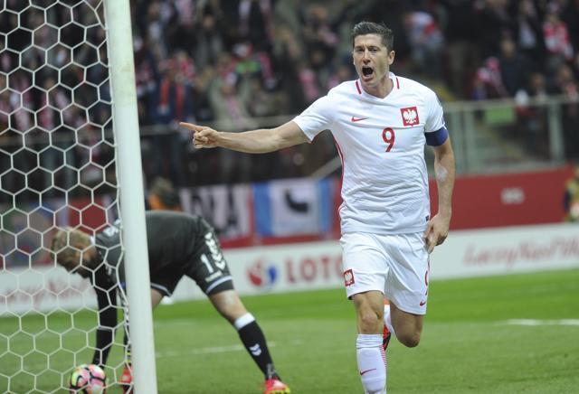 Poland’s Robert Lewandowski celebrates after scoring a goal as Denmark's goalkeeper Kasper Schmeichel, left, picks the ball. (AP) Poland’s Robert Lewandowski celebrates after scoring a goal as Denmark's goalkeeper Kasper Schmeichel, left, picks the ball. (AP)