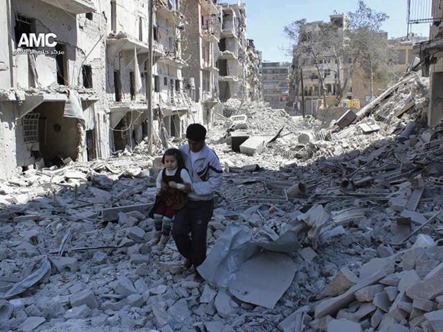 A Syrian man holding a girl as he stands on the rubble of houses that were destroyed by Syrian government forces air strikes in Aleppo, Syria. (AP File Photo) A Syrian man holding a girl as he stands on the rubble of houses that were destroyed by Syrian government forces air strikes in Aleppo, Syria. (AP File Photo)