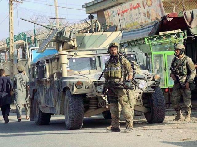 Afghan security forces keep watch in front of their armoured vehicle in Kunduz city. (Reuters File Photo) Afghan security forces keep watch in front of their armoured vehicle in Kunduz city. (Reuters File Photo)