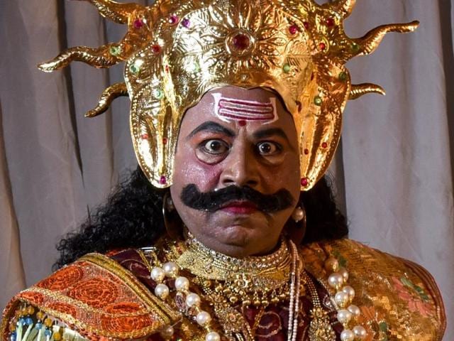 Rajesh Rastogi( dressed as demon king ‘Ravana’ laughs during a religious procession at Malad in Mumbai. (Kunal Patil/HT Photo)