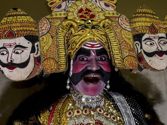 Ashok Kumar Dixit, dressed as Ravana, laughs during a religious procession. (Kunal Patil/HT Photo)