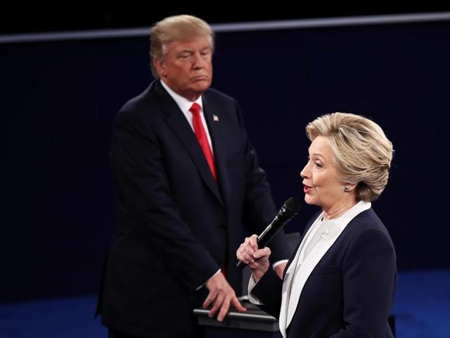Democratic presidential nominee and former secretary of state Hillary Clinton (right) speaks as Trump looks on during the town hall debate at Washington University. (AFP Photo) Democratic presidential nominee and former secretary of state Hillary Clinton (right) speaks as Trump looks on during the town hall debate at Washington University. (AFP Photo)