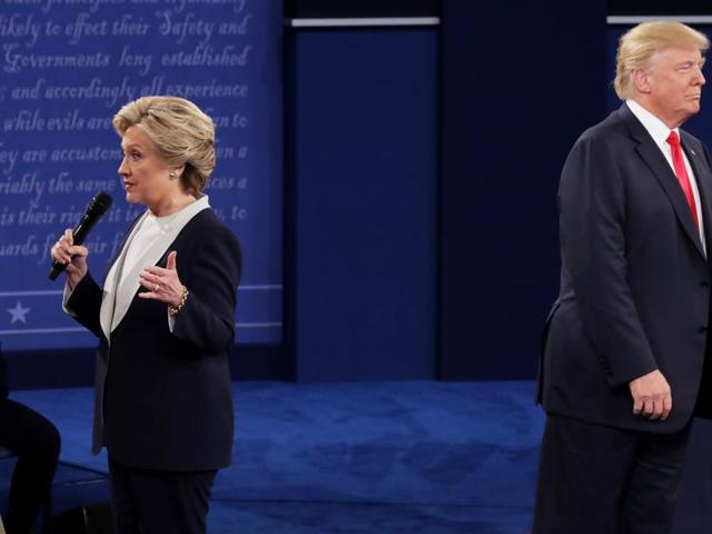 Democratic presidential nominee former Secretary of State Hillary Clinton (left) speaks as Republican presidential nominee Donald Trump looks on during the town hall debate at Washington University on Sunday. (AFP) Democratic presidential nominee former Secretary of State Hillary Clinton (left) speaks as Republican presidential nominee Donald Trump looks on during the town hall debate at Washington University on Sunday. (AFP)