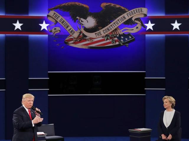 Trump speaks as Democratic presidential nominee former secretary of state Hillary Clinton looks on during the town hall debate. (AFP Photo) Trump speaks as Democratic presidential nominee former secretary of state Hillary Clinton looks on during the town hall debate. (AFP Photo)