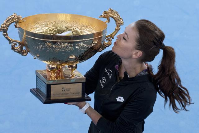 Agnieszka Radwanska of Poland kisses the trophy after defeating Johanna Konta of Britain. (AP Photo)