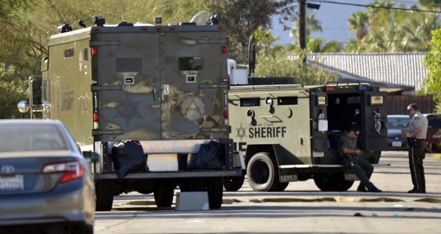 Riverside County sheriff's deputies wait in front of a house where a suspect was apprehended. (AP Photo) Riverside County sheriff's deputies wait in front of a house where a suspect was apprehended. (AP Photo)