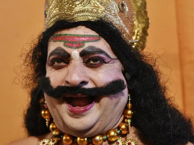 Pradeep Sharma laughs while playing the role of ‘Ravana’ at the Ram Lila Ground in New Delhi. (Saumya Khandelwal/HT Photo)