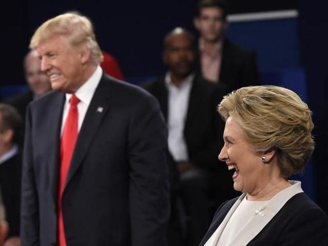 Republican US presidential nominee Donald Trump and Democrat presidential nominee Hillary Clinton react as an audience member asks the candidates to say what they admire about each other during their presidential town hall debate at Washington University in St. Louis, Missouri. (Reuters Photo) Republican US presidential nominee Donald Trump and Democrat presidential nominee Hillary Clinton react as an audience member asks the candidates to say what they admire about each other during their presidential town hall debate at Washington University in St. Louis, Missouri. (Reuters Photo)