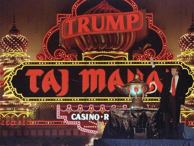 In this April 5, 1990 file photo, Donald Trump stands next to a genie's lamp as the lights of his Trump Taj Mahal Casino Resort light up during ceremonies to mark its opening in Atlantic City, NJ.(AP)