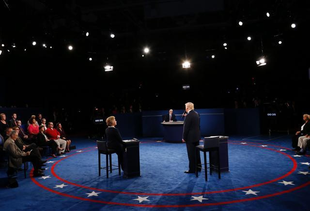 US Republican presidential candidate Donald Trump speaks Clinton listens during the second presidential debate. (AFP Photo) US Republican presidential candidate Donald Trump speaks Clinton listens during the second presidential debate. (AFP Photo)
