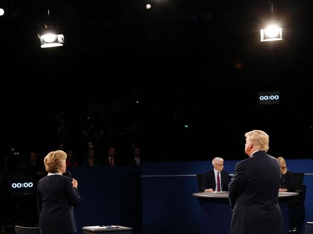Democratic presidential nominee former Secretary of State Hillary Clinton speaks as Republican presidential nominee Donald Trump looks on during the town hall debate at Washington University. (AFP Photo) Democratic presidential nominee former Secretary of State Hillary Clinton speaks as Republican presidential nominee Donald Trump looks on during the town hall debate at Washington University. (AFP Photo)