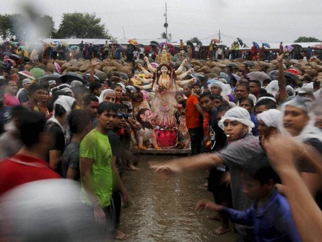 Devotees prepare to immerse an idol of Hindu Goddess Durga on the last day of Durga Puja festival at the Patenga beach in Chittagong, Bangladesh. (AP Photo)