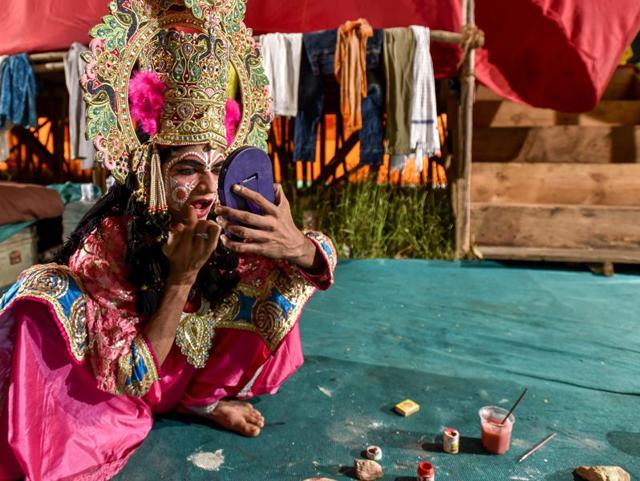 An artiste from Mathura in Uttar Pradesh gets ready before his performance at the Shri Ramleela Utsav Play Festival at Azad Maidan in Mumbai. Ramleela is a dramatic folk re-enactment of the life of Rama, ending up in ten-day battle between Rama and Ravana, as described in the Hindu religious epic, the Ramayana. (Kunal Patil/HT photo)