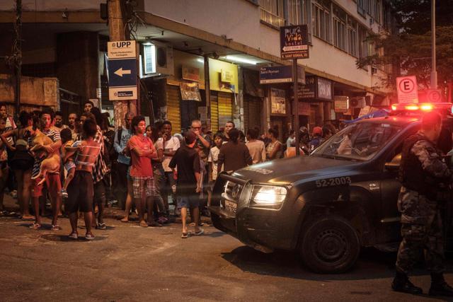 Locals look at the police operation following clashes between drug dealers inside the Pavao-Pavaozinho favela -between Copacabana and Ipanema in Rio de Janeiro, Brazil, on Monday. (AFP) Locals look at the police operation following clashes between drug dealers inside the Pavao-Pavaozinho favela -between Copacabana and Ipanema in Rio de Janeiro, Brazil, on Monday. (AFP)