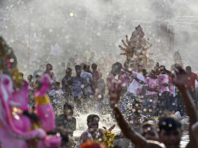 On the occasion of Dussehra, the tenth day after Navratri, the idol of Goddess Durga is being immersed in the Yamuna in New Delhi. (Saumya Khandelwal/HT Photo)