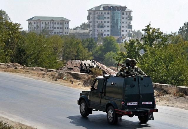 An army vehicle moves towards the multistoried government building where some militants were holed up during a gunbattle, at Pampore. (PTI Photo) An army vehicle moves towards the multistoried government building where some militants were holed up during a gunbattle, at Pampore. (PTI Photo)