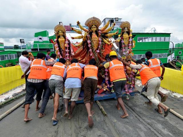 Municipal workers carry a Durga idol for immersion in the waters of the river Brahmaputra on the last day of the Durga Puja festival in Guwahati. (Anuwar Hazarika/REUTERS)