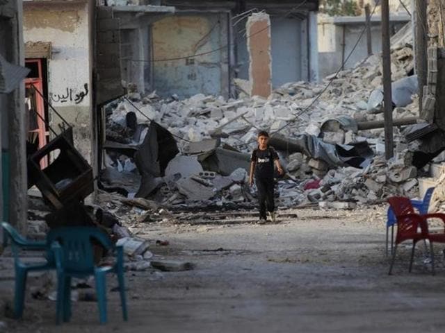 A boy walks past damaged buildings in the northern Syrian rebel-held town of al-Waqf, in Aleppo. (Reuters) A boy walks past damaged buildings in the northern Syrian rebel-held town of al-Waqf, in Aleppo. (Reuters)