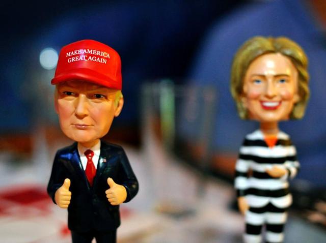 Bobble head figurines of Republican presidential nominee Donald Trump and Democratic presidential nominee Hillary Clinton greet Republican party supporters registering to watch a presidential debate watch party hosted by the Colorado Republican Party at Choppers Sports Grill in Denver.(AFP) Bobble head figurines of Republican presidential nominee Donald Trump and Democratic presidential nominee Hillary Clinton greet Republican party supporters registering to watch a presidential debate watch party hosted by the Colorado Republican Party at Choppers Sports Grill in Denver.(AFP)